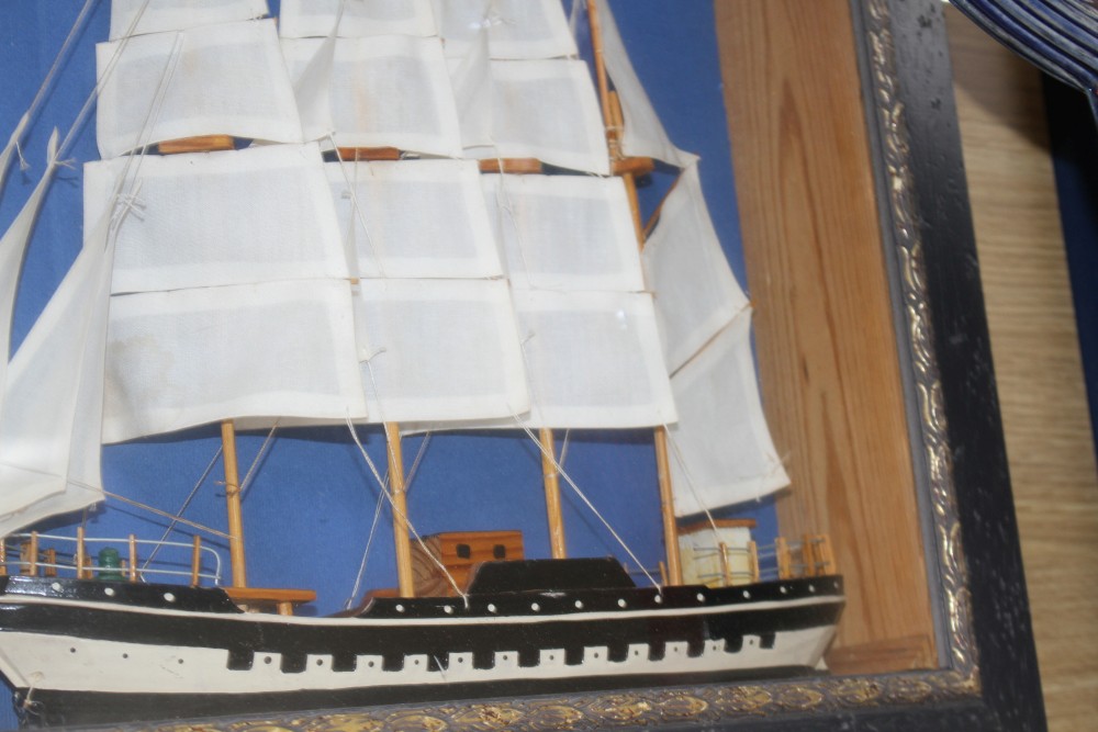 A painted wood ship model, in display frame, overall 42 x 52cm
